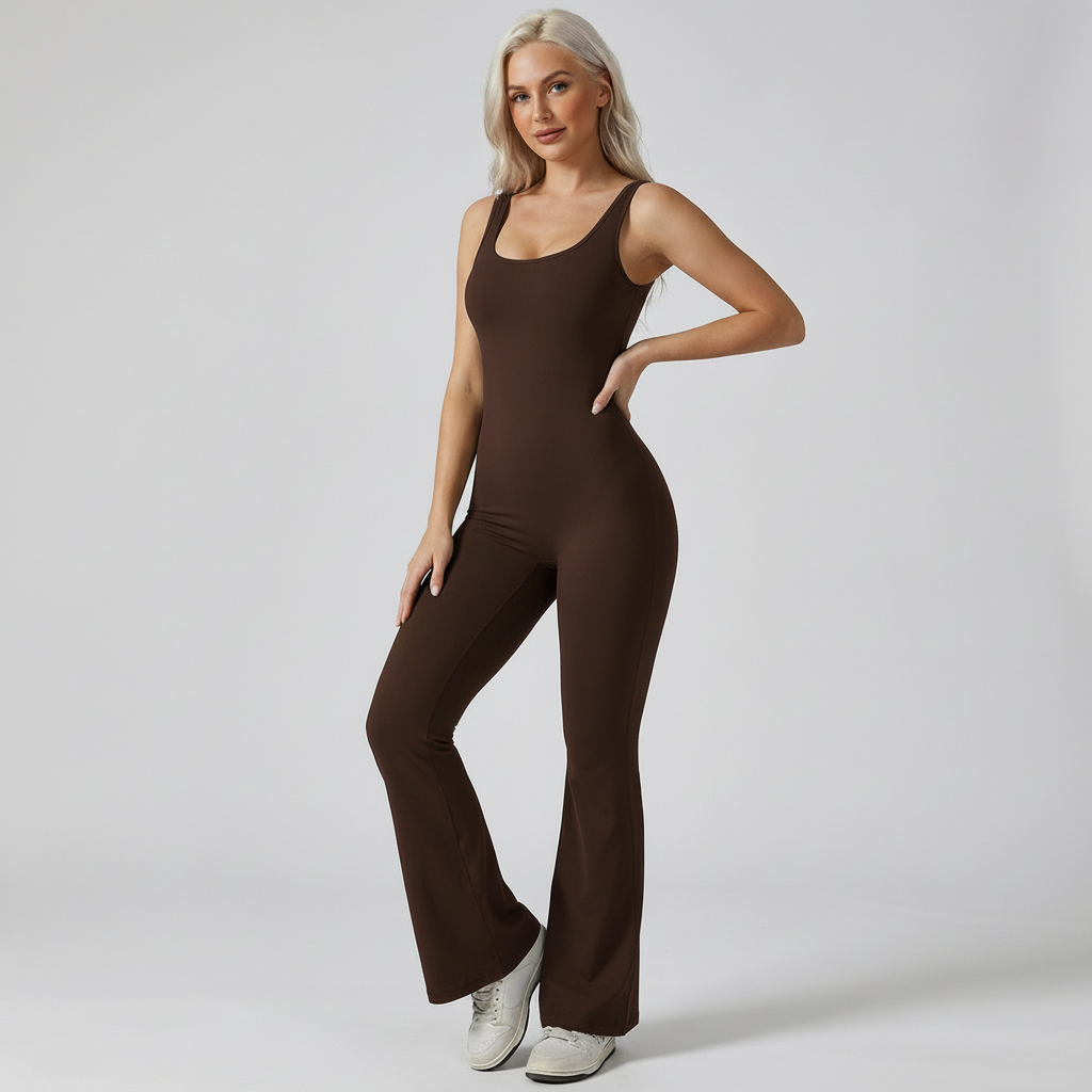 Woman wearing a brown jumpsuit on a plain background