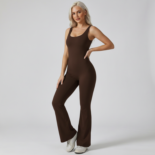 Woman wearing a brown jumpsuit on a plain background