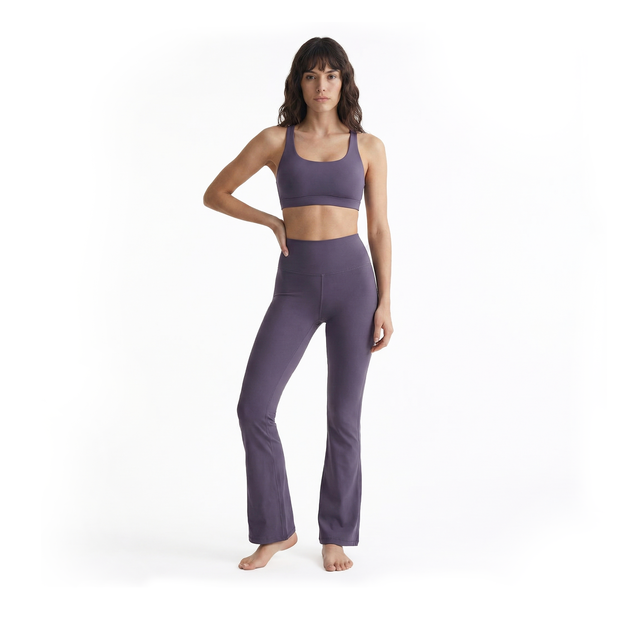 Woman wearing purple bootcut leggings on a white background, front view