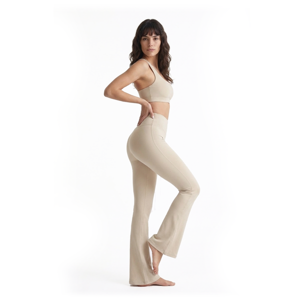 Woman wearing a beige outfit on a white background