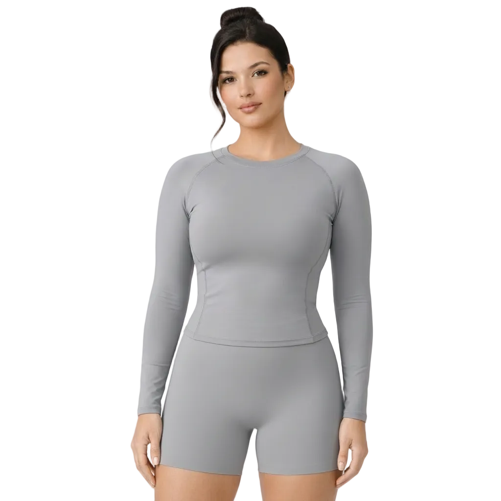 Woman wearing a gray long-sleeve top and shorts set on a light gray background