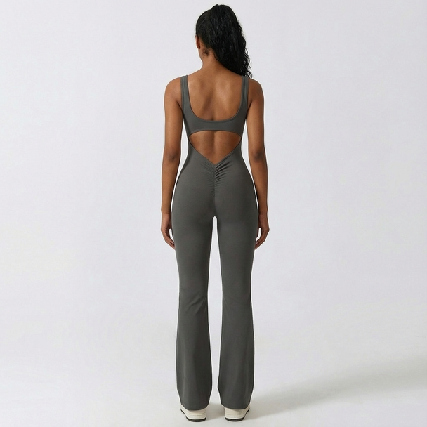 Person wearing a gray jumpsuit with cut-out design on a white background