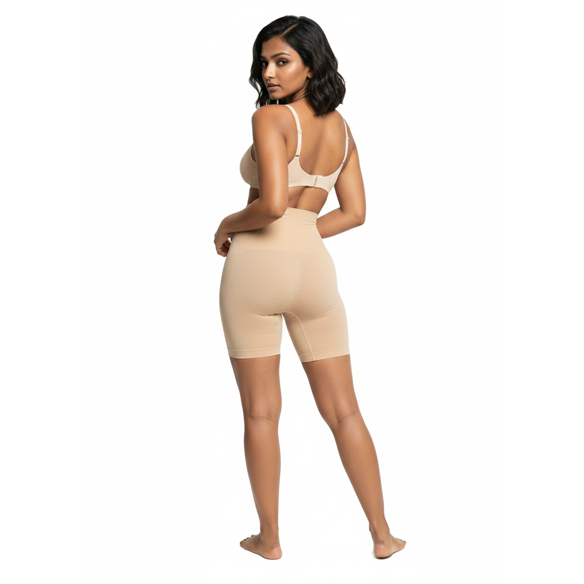 Woman wearing a beige high waist shorts on a white background, back view