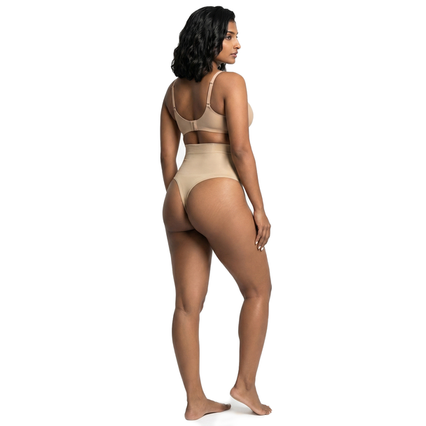 Woman wearing beige high waist shaping thong on a white background