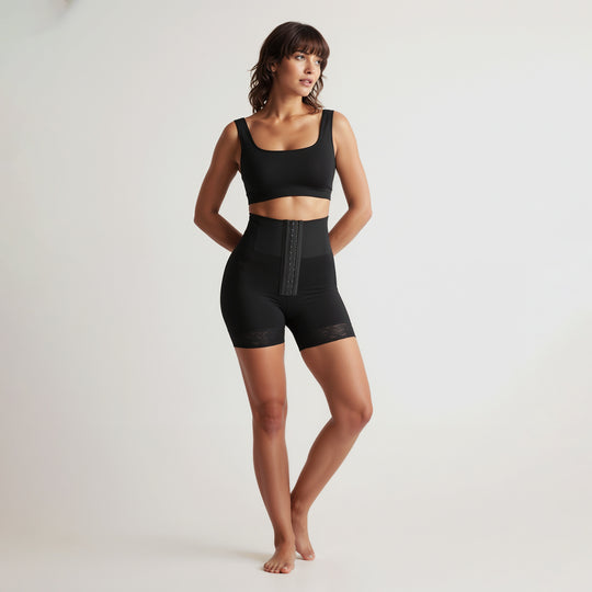 Woman wearing a black athletic outfit on a white background