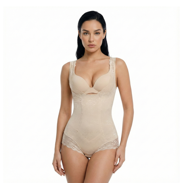 Woman wearing a beige open-bust bodysuit on a white background, front view