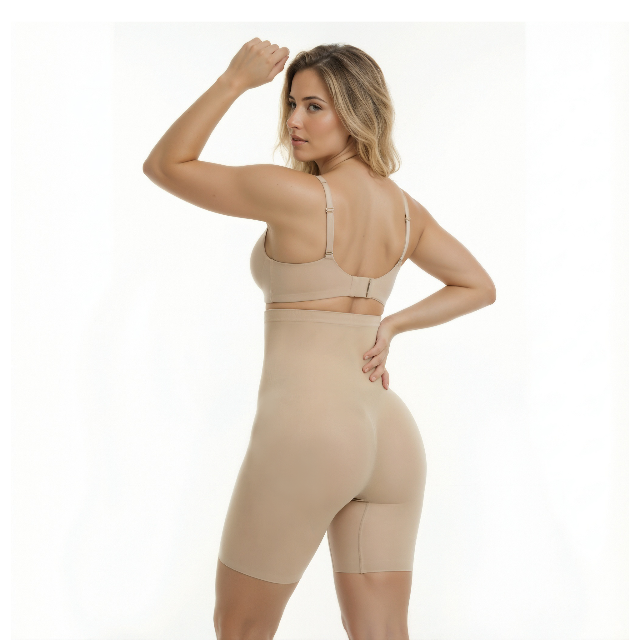 Woman wearing a beige shapewear outfit on a white background