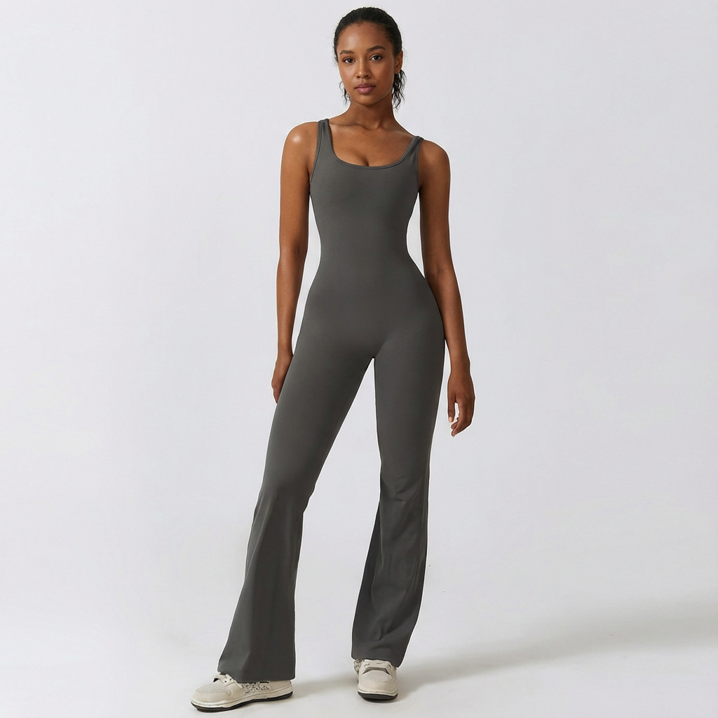 Woman wearing a gray jumpsuit on a white background