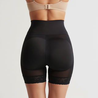 Black shapewear shorts with lace trim on a neutral background