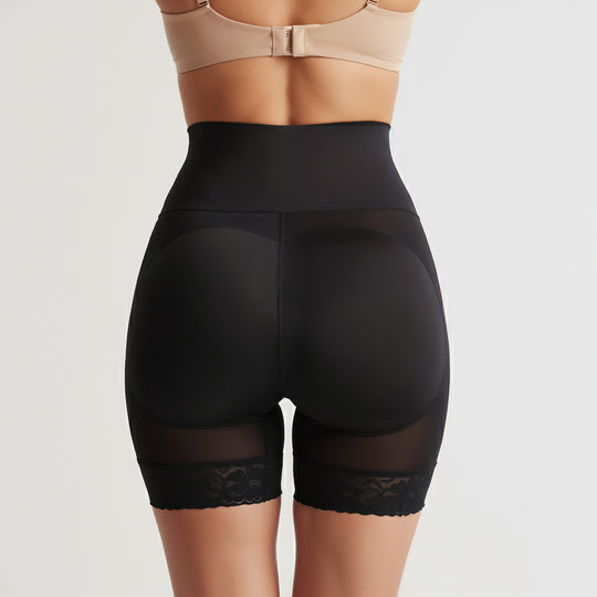 Black shapewear shorts with lace trim on a neutral background