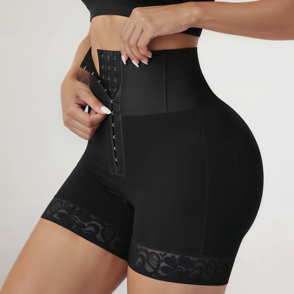 Black shapewear shorts with lace details on a plain background